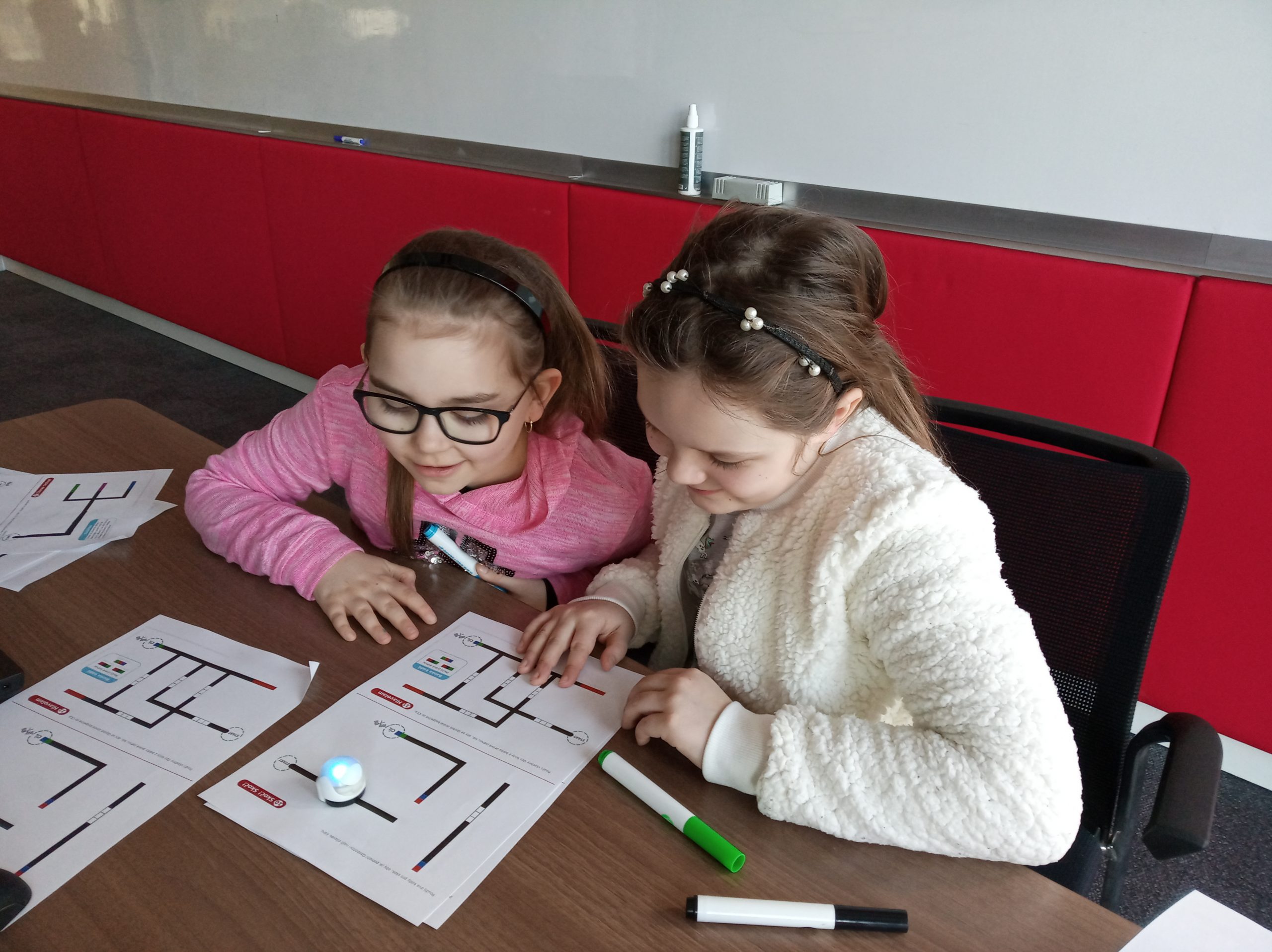 Two girls playing with ozobot